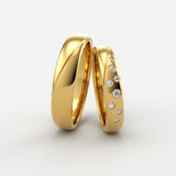 Vielsesringe i guld med bølgesnit og graderede diamanter – EG09