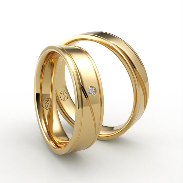 Guld vielsesringe med diagonal gravering og én diamant – EG40 - side